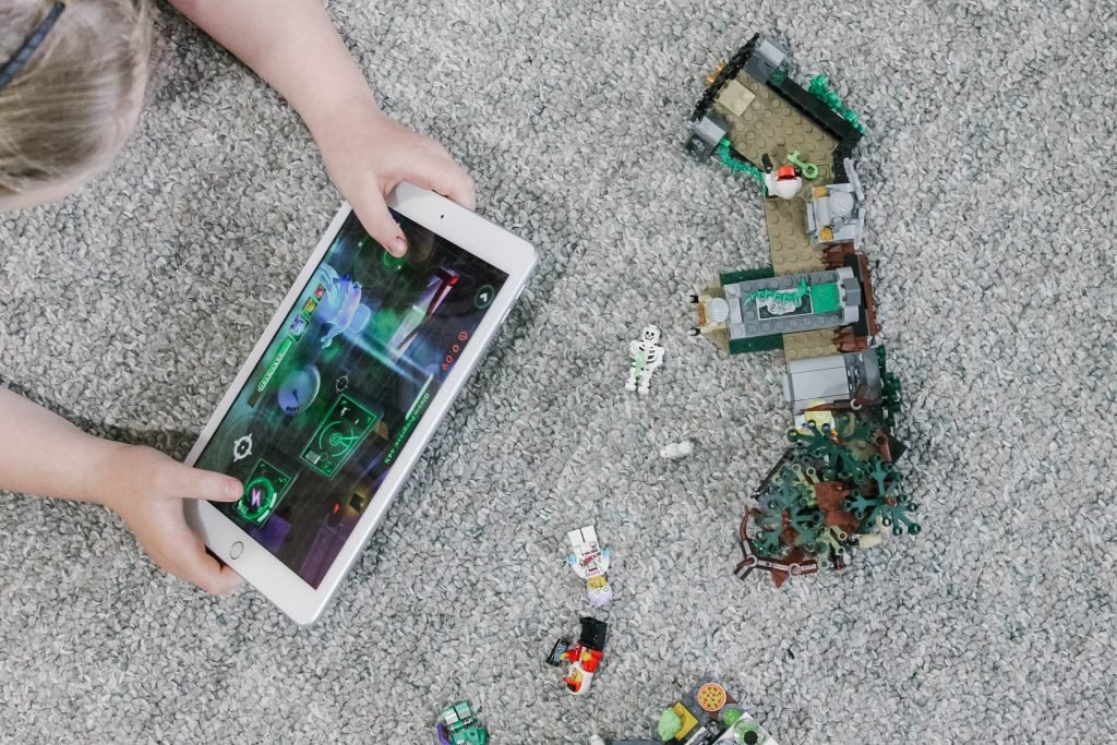 LEGO hidden side app being played with set shown on carpet