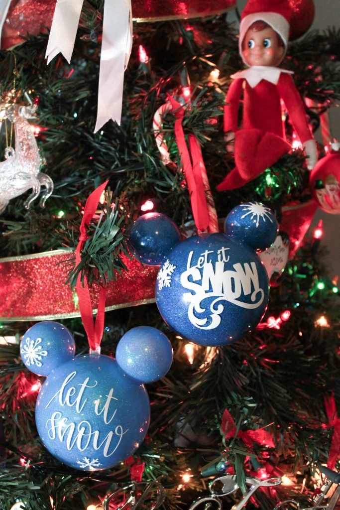 Up close view of Let it snow ornaments on Christmas tree