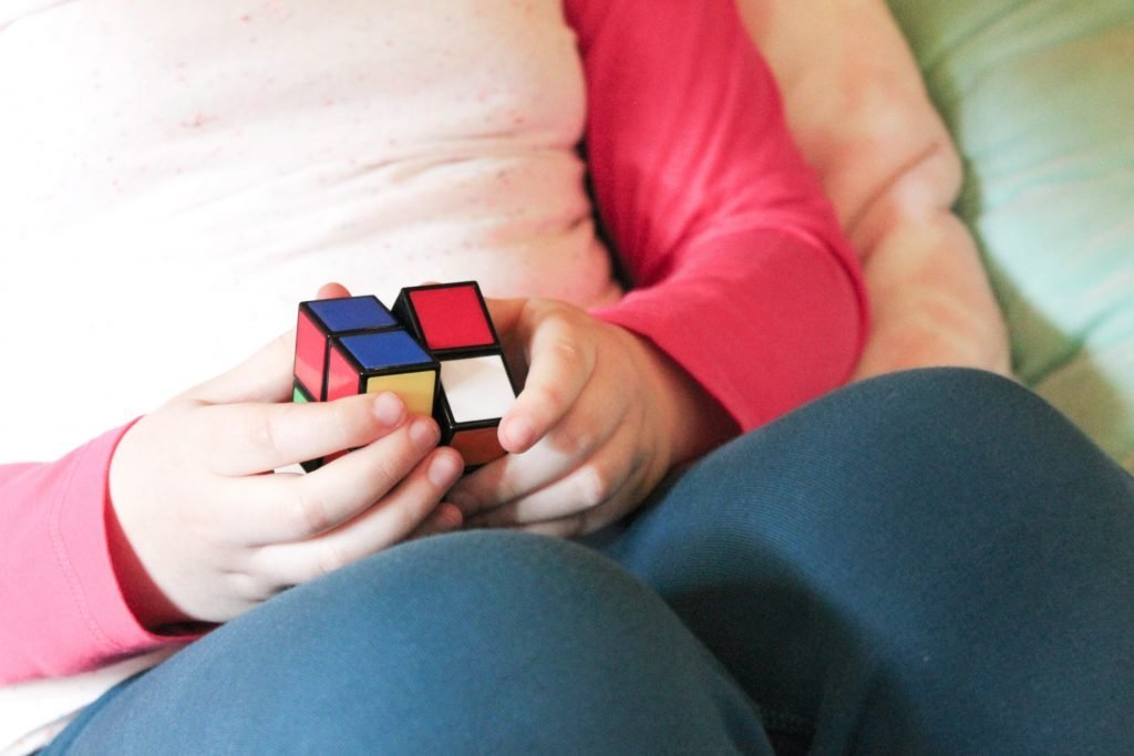 Child's Hands Solving Rubik's Cube