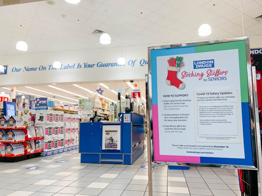 Image of inside London Drugs location with Stocking Stuffers for Seniors information board in front