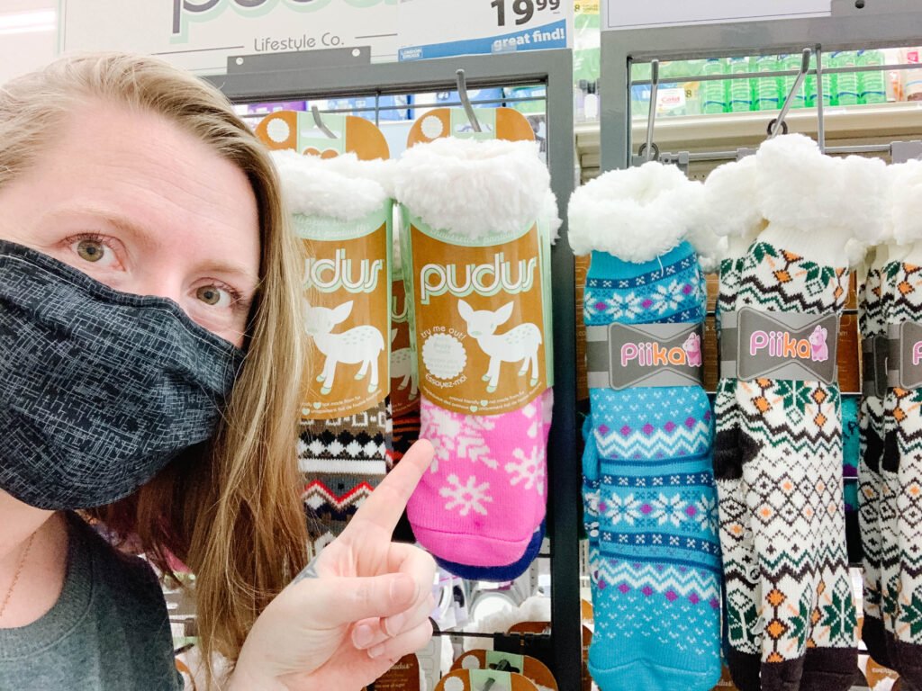 Woman posing with finger pointed at Pudus warm socks in London Drugs