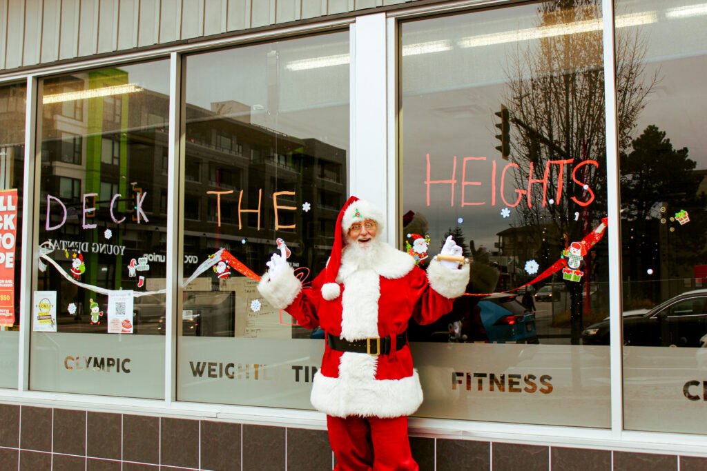 Deck The Heights Santa standing outside of gym on Hastings Street